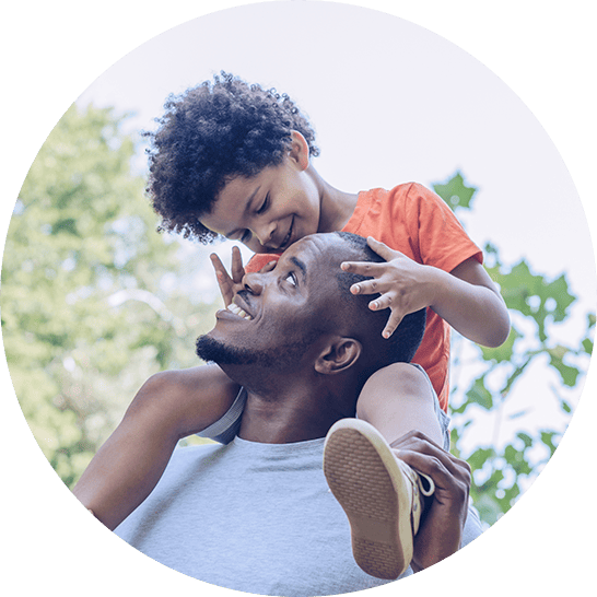 Child sitting atop father's shoulders